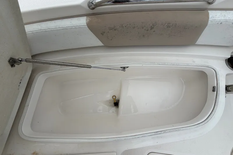 Slide: The Image of Open storage compartment on a 2019 Robalo 226 Cayman boat. - 43