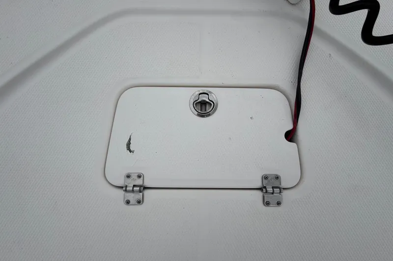 Slide: The Image of Hatch cover on 2019 Robalo 226 Cayman boat deck with visible hinges and wiring. - 45