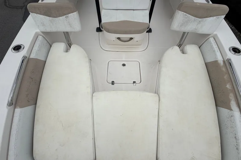 Slide: The Image of 2019 Robalo 226 Cayman boat interior with white cushioned seating. - 52
