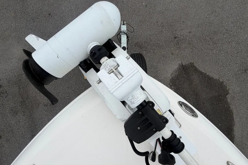 Slide: The Image of A white outboard motor is mounted on a boat, resting on a gray surface. - 47