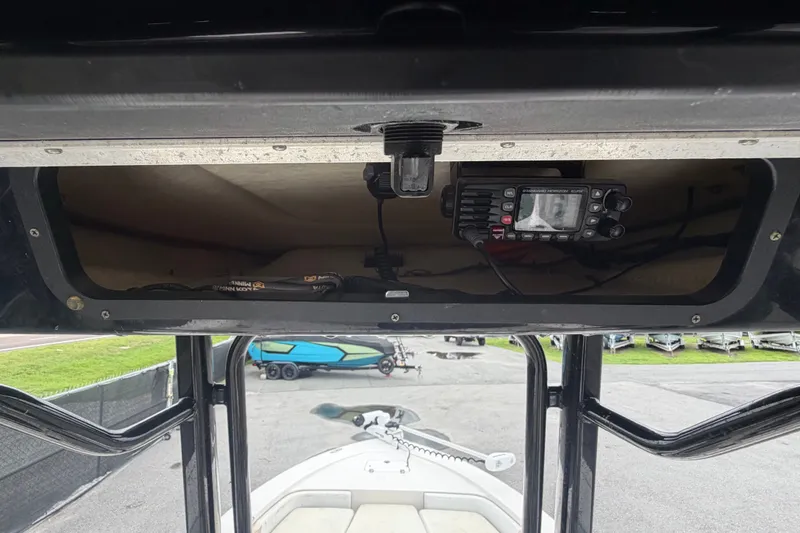 Slide: The Image of A 2019 Robalo 226 Cayman with an electronic device in the overhead compartment. - 29