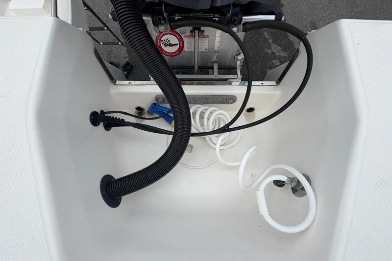 Slide: The Image of 2019 Robalo 226 Cayman boat interior with cables and hoses visible. - 74