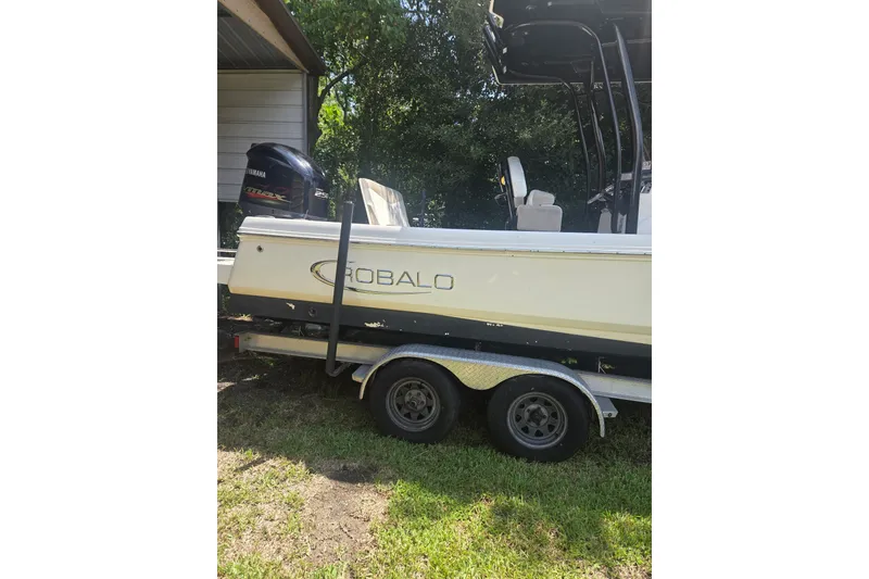Slide: The Image of 2019 Robalo 226 Cayman boat on trailer, featuring Yamaha engine, parked outdoors. - 3