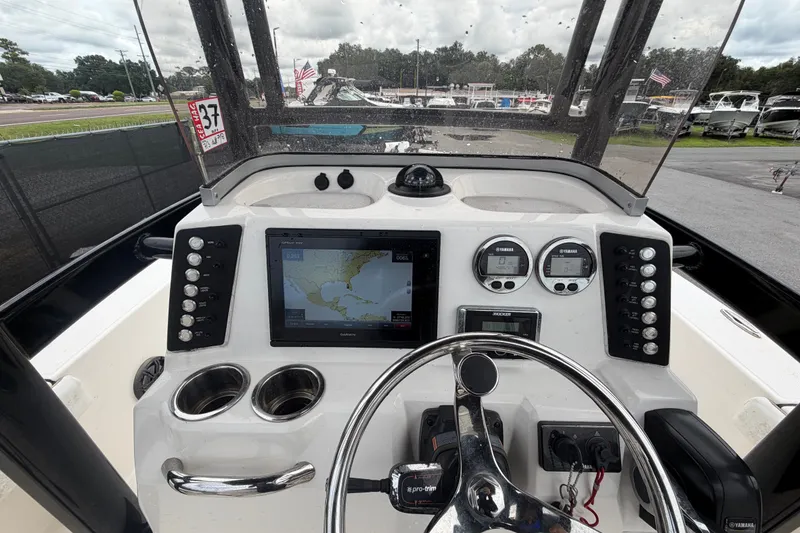 Slide: The Image of 2019 Robalo 226 Cayman boat dashboard with navigation system and controls. - 21