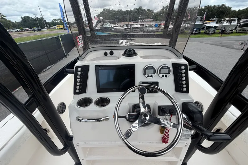 Slide: The Image of 2019 Robalo 226 Cayman boat dashboard with steering wheel and control panel. - 20