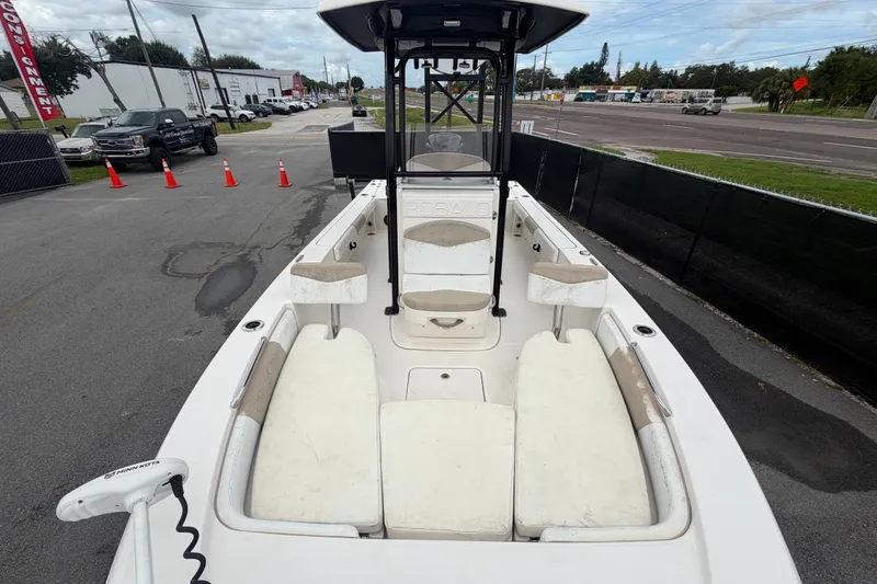 Slide: The Image of 2019 Robalo 226 Cayman boat with seating, parked on a street near traffic cones. - 50