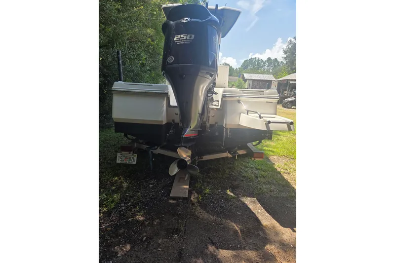 Slide: The Image of 2019 Robalo 226 Cayman boat with powerful outboard motor, parked on grass. - 14