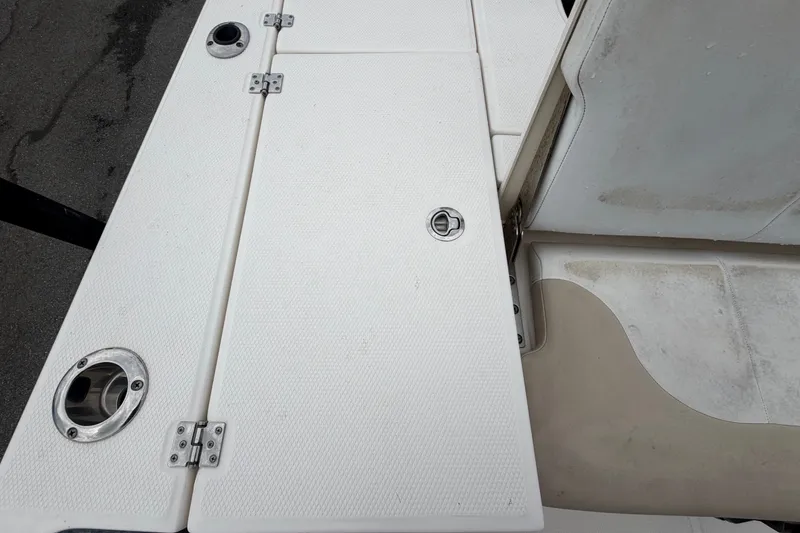 Slide: The Image of 2019 Robalo 226 Cayman boat deck with storage compartments and stainless steel fittings. - 63