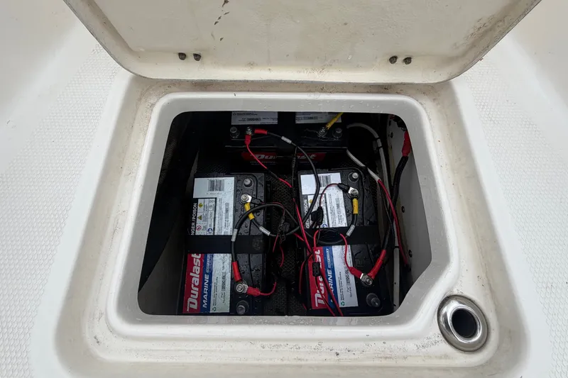 Slide: The Image of Battery compartment of a 2019 Robalo 226 Cayman with two Duralast batteries and wiring. - 34