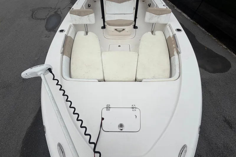 Slide: The Image of The image shows the deck of a 2019 Robalo 226 Cayman with white cushions and a trolling motor. - 49