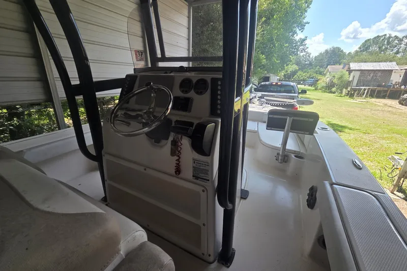 Slide: The Image of 2019 Robalo 226 Cayman boat interior with steering wheel and console. - 7