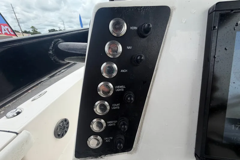 Slide: The Image of Control panel of a 2019 Robalo 226 Cayman boat with various switches. - 22