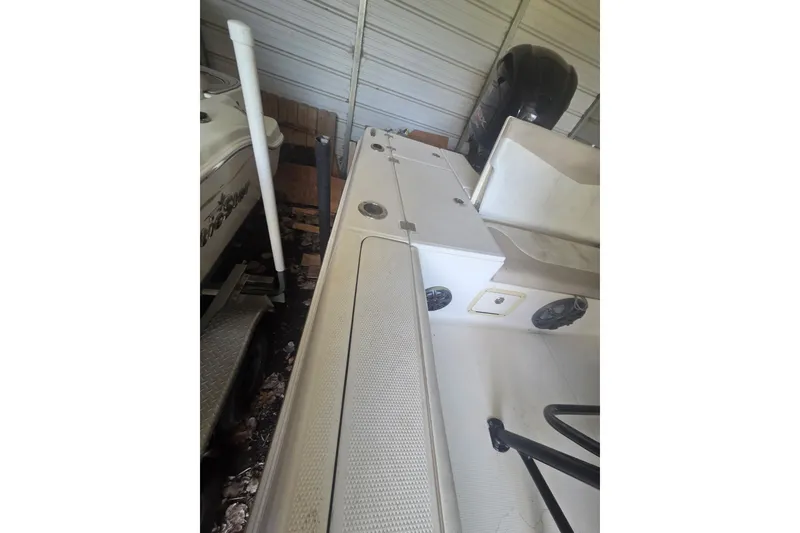 Slide: The Image of 2019 Robalo 226 Cayman boat interior in storage, featuring seating and equipment. - 10