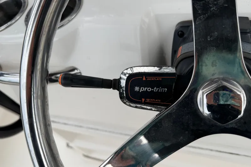 Slide: The Image of Steering wheel with Pro-Trim jackplate control on 2019 Robalo 226 Cayman boat. - 26