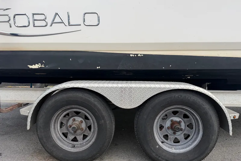 Slide: The Image of 2019 Robalo 226 Cayman boat on trailer with visible wear. - 84