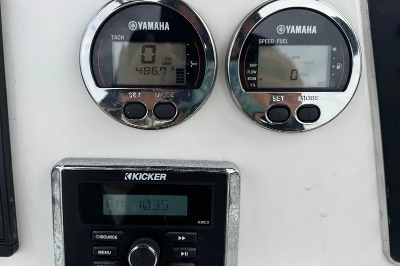 Slide: The Image of Yamaha gauges and Kicker stereo on 2019 Robalo 226 Cayman boat dashboard. - 24