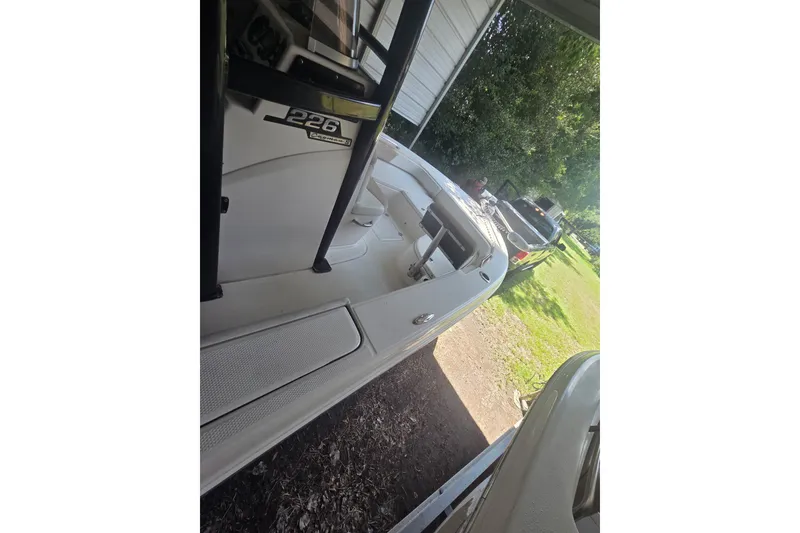Slide: The Image of 2019 Robalo 226 Cayman boat parked outdoors near a truck. - 9