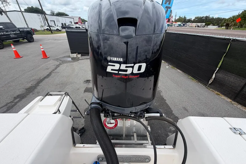 Slide: The Image of 2019 Robalo 226 Cayman with Yamaha 250 outboard engine, parked outdoors. - 79