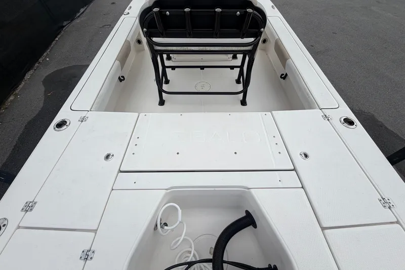 Slide: The Image of The image shows the cockpit of a 2019 Robalo 226 Cayman with white seating and storage. - 13