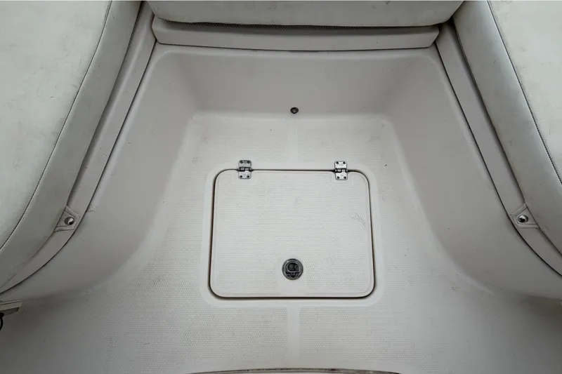 Slide: The Image of The image shows the floor area of a boat with a small, square access hatch. - 33
