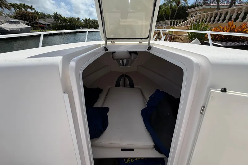 Slide: The Image of 2008 Donzi 29 ZF Cuddy cabin interior with open hatch, dockside view. - 18
