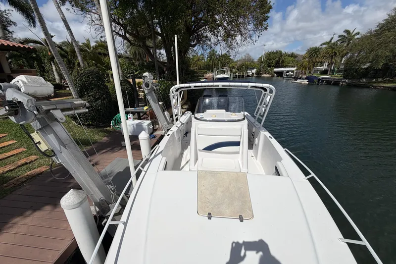 Slide: The Image of 2008 Donzi 29 ZF Cuddy boat docked by a scenic waterfront. - 19