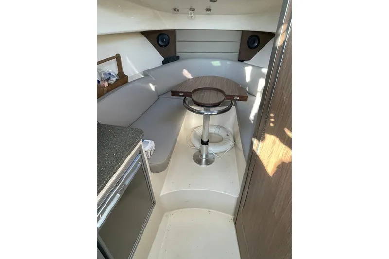 Slide: The Image of Interior of 2012 Boston Whaler 285 Conquest boat with seating and table. - 14