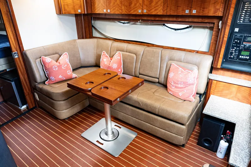 Slide: The Image of Luxurious 2008 Monterey 400 Sport Yacht interior with leather seating and nautical-themed pillows. - 9