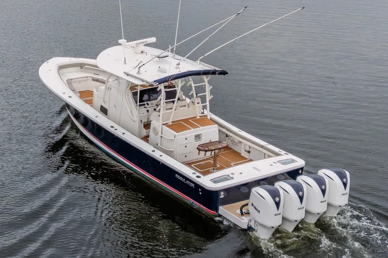 Slide: The Image of 2018 Regulator 41 boat with four Yamaha engines cruising on water. - 3