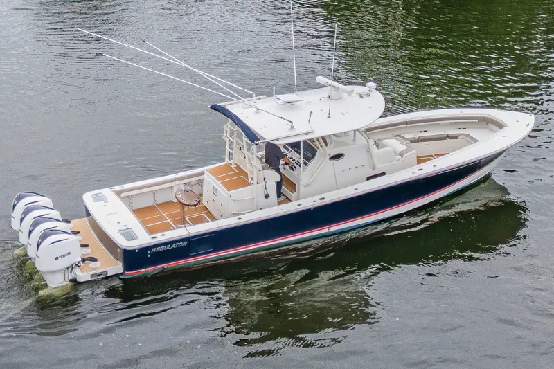 Slide: The Image of 2018 Regulator 41 boat with triple Yamaha engines on calm water. - 10