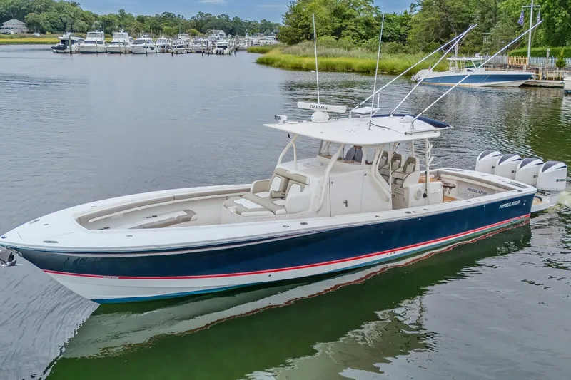 The Image of 2018 Regulator 41 boat on calm water, featuring sleek design and multiple engines. - 1