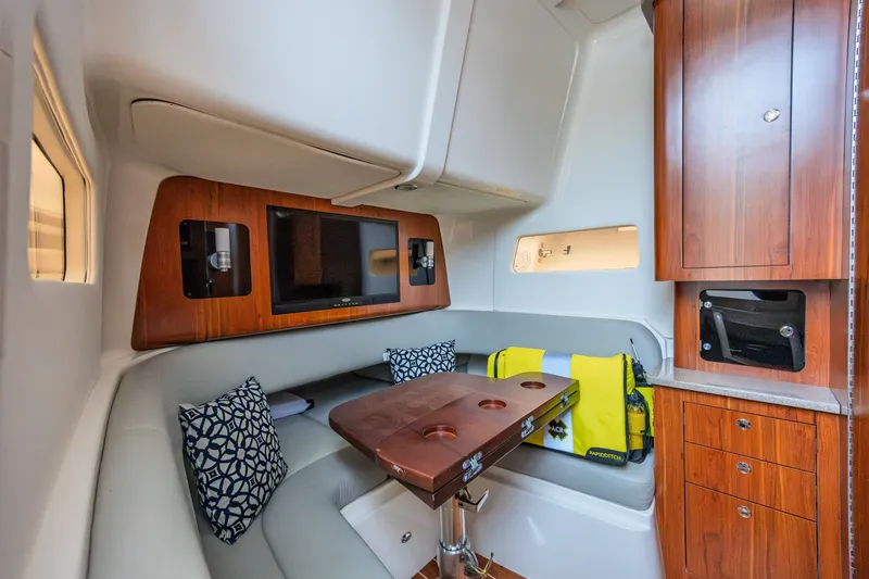 Slide: The Image of Luxurious interior of 2018 Regulator 41 boat with seating, table, and cabinetry. - 13