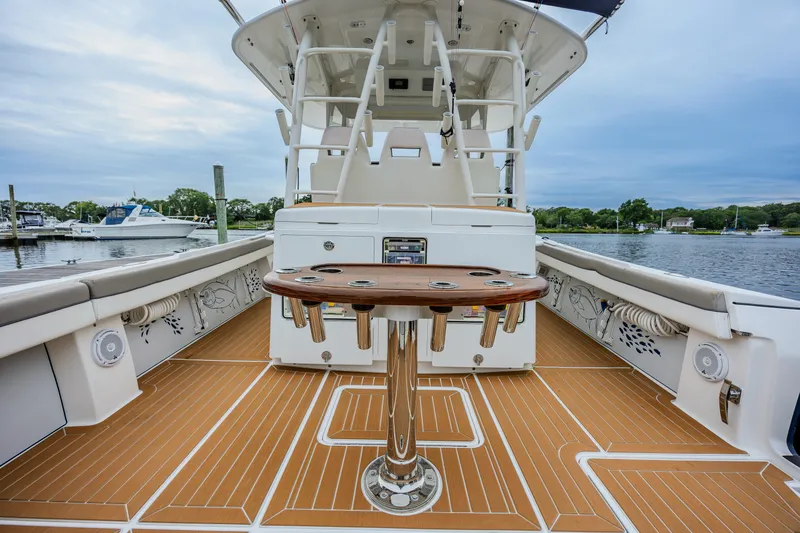 Slide: The Image of 2018 Regulator 41 boat deck with fishing rod holders, docked in a marina. - 17