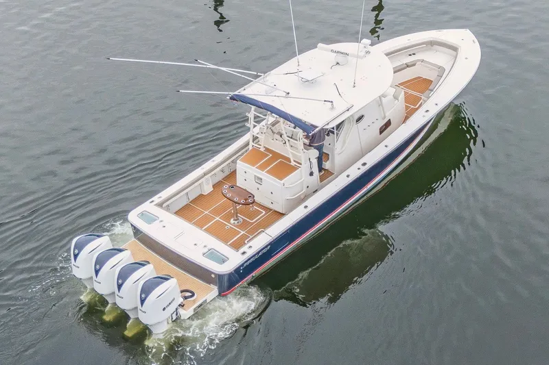 Slide: The Image of 2018 Regulator 41 boat with triple outboard engines on calm water. - 2