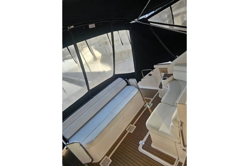 Slide: The Image of 2007 Regal Commodore 4460 yacht interior with white seating and wood flooring. - 14