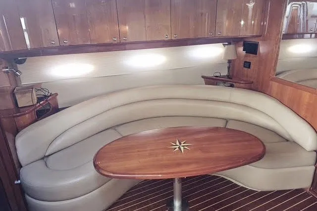 Slide: The Image of Luxurious interior of 2007 Regal Commodore 4460 yacht with elegant seating and wooden table. - 13