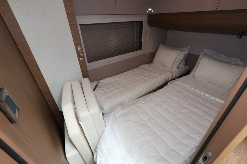 Slide: The Image of 2019 Beneteau Gran Turismo 50 cabin with twin beds, modern design, and cozy interior. - 29