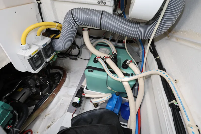 Slide: The Image of Engine room of 2019 Beneteau Gran Turismo 50 with hoses and electrical components. - 38