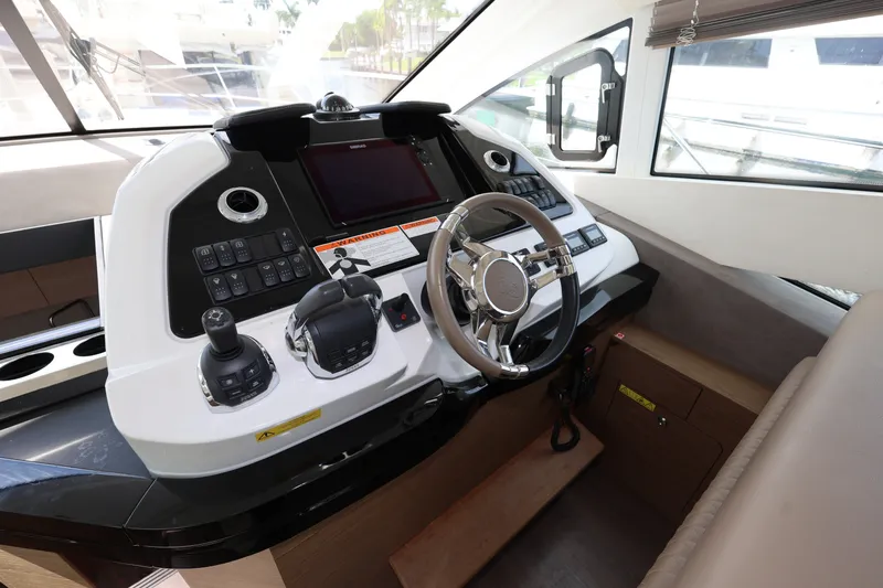 Slide: The Image of Cockpit of 2019 Beneteau Gran Turismo 50 yacht with modern controls and steering wheel. - 21