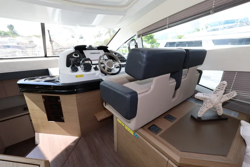 Slide: The Image of 2019 Beneteau Gran Turismo 50 helm station with modern controls and plush seating. - 19