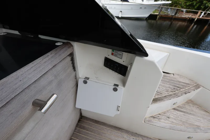 Slide: The Image of 2019 Beneteau Gran Turismo 50 yacht deck with control panel and wooden steps. - 14