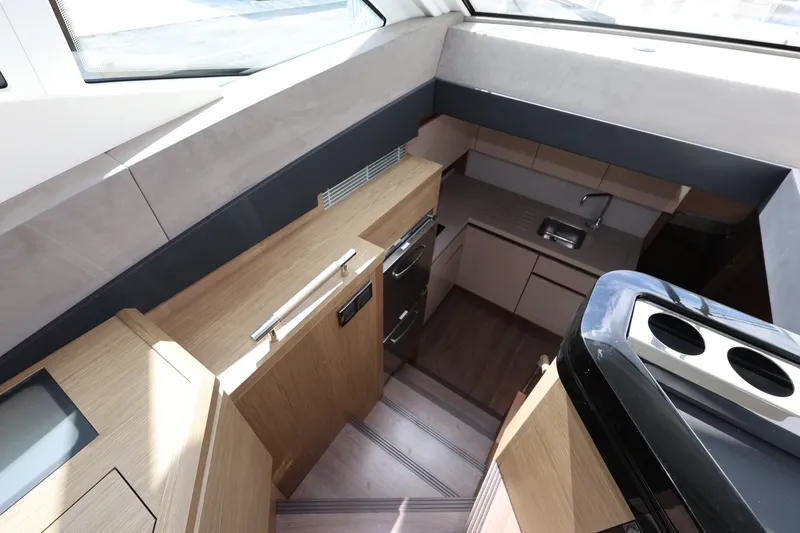Slide: The Image of Luxurious interior of 2019 Beneteau Gran Turismo 50 yacht, featuring modern kitchen design. - 23