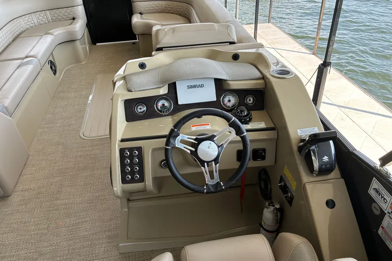 Slide: The Image of 2023 Crest Caribbean LX 250 boat interior with steering wheel and control panel. - 17