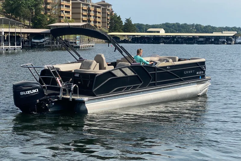 Slide: The Image of 2023 Crest Caribbean LX 250 pontoon boat on a lake with Suzuki outboard motor. - 60