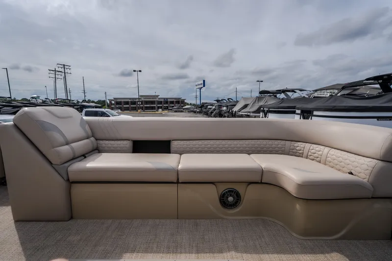 Slide: The Image of 2023 Crest Caribbean LX 250 boat interior with luxurious beige seating and speaker system. - 50