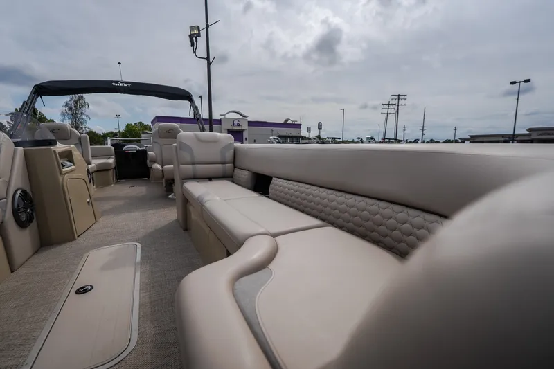 Slide: The Image of 2023 Crest Caribbean LX 250 pontoon boat interior with luxurious seating and modern design. - 44