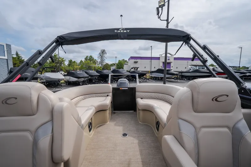 Slide: The Image of 2023 Crest Caribbean LX 250 pontoon boat interior with plush seating and modern design. - 56