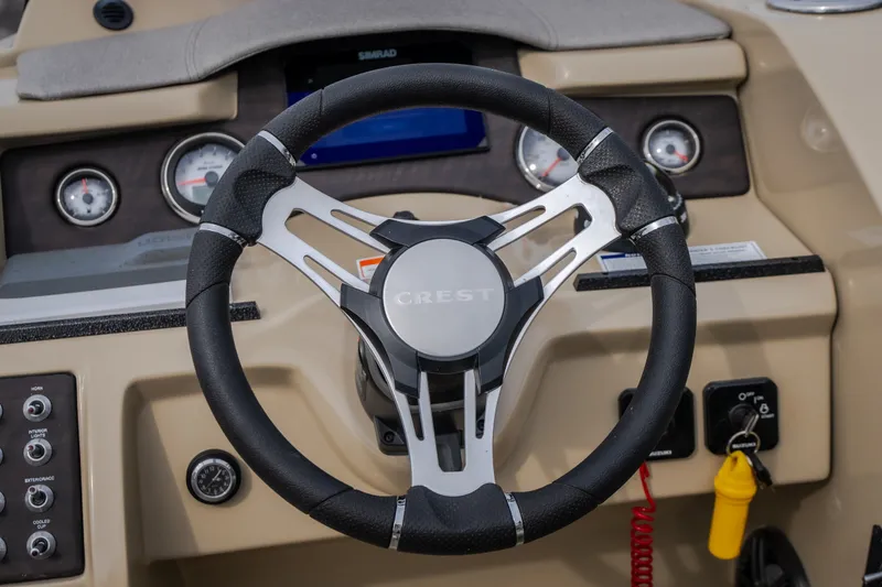 Slide: The Image of Steering wheel of 2023 Crest Caribbean LX 250 boat with dashboard controls. - 34