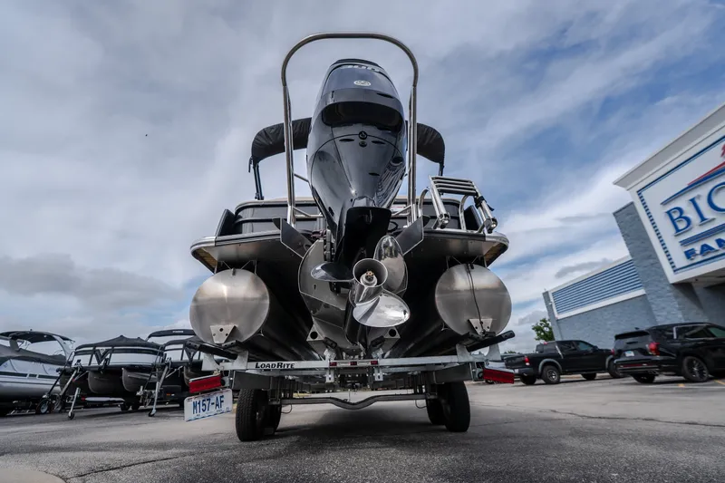 Slide: The Image of 2023 Crest Caribbean LX 250 pontoon boat on trailer, displayed at dealership. - 24