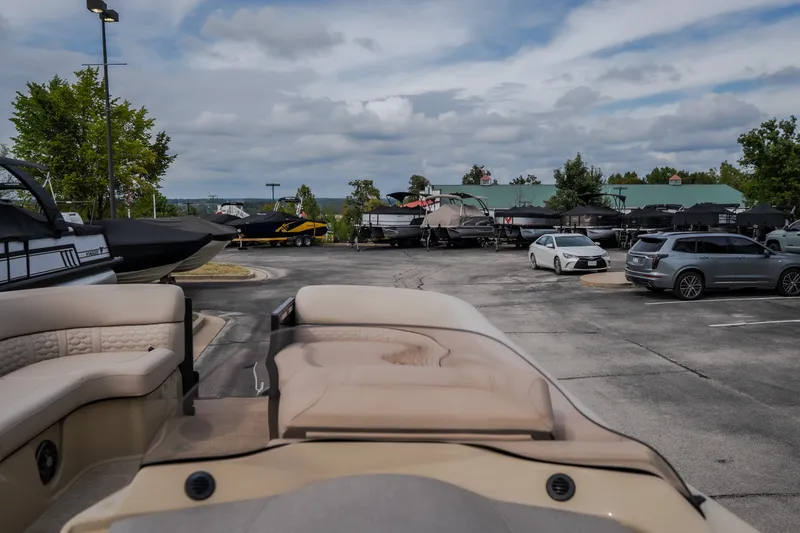 Slide: The Image of 2023 Crest Caribbean LX 250 boat in a parking lot with cars and other boats. - 36